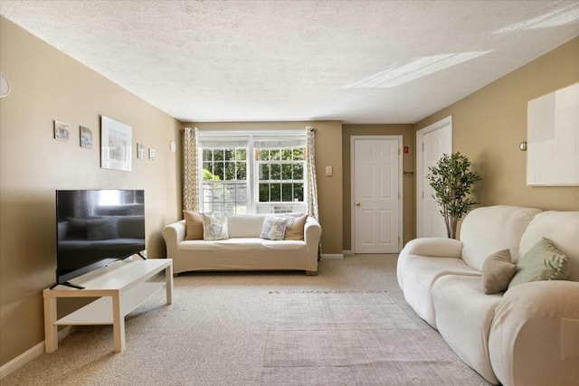 living area with carpet flooring, baseboards, and a textured ceiling