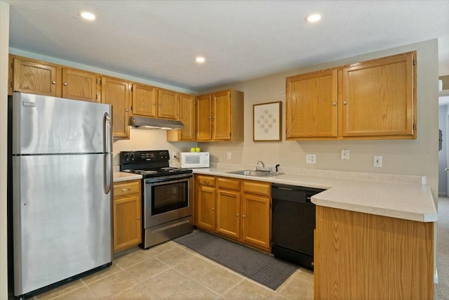 kitchen with under cabinet range hood, stainless steel appliances, light countertops, and a sink