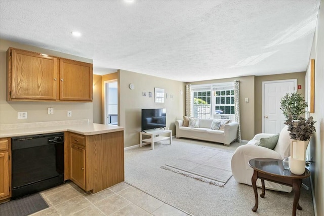 kitchen featuring black dishwasher, a peninsula, open floor plan, and light countertops