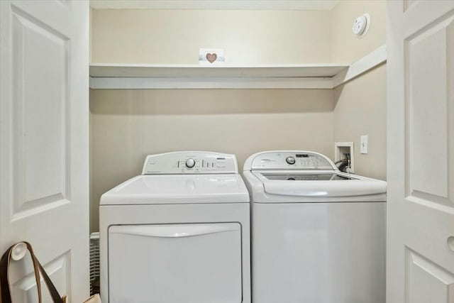 washroom featuring laundry area and washing machine and dryer