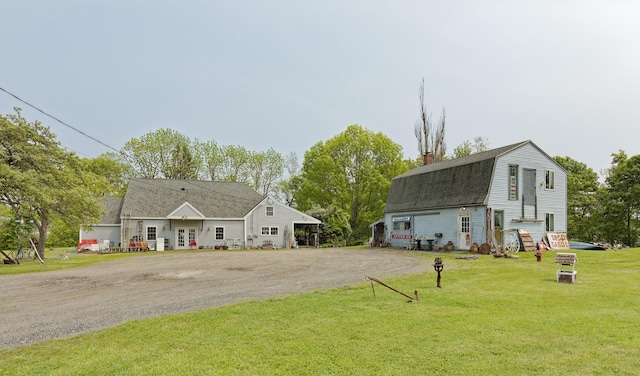 535 Main St, Damariscotta, ME 04543 - view of front of home with a gambrel roof, a front yard, roof with shingles, driveway, and a chimney