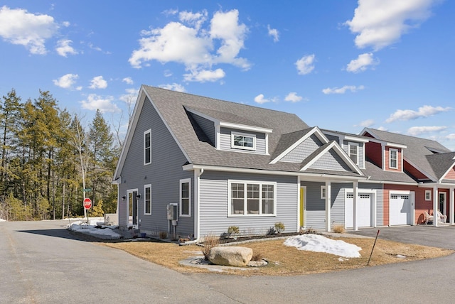 view of front of property featuring aphalt driveway and a shingled roof