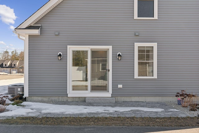 doorway to property featuring central air condition unit