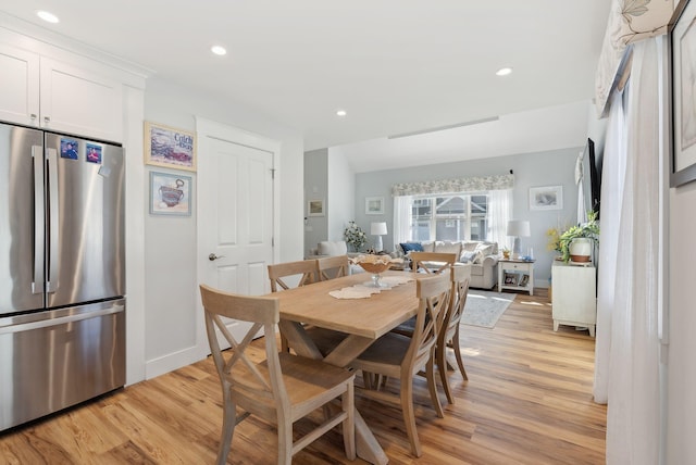 dining space with recessed lighting, baseboards, and light wood finished floors