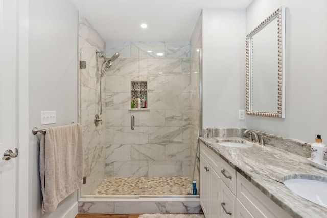 bathroom featuring double vanity, recessed lighting, a stall shower, and a sink