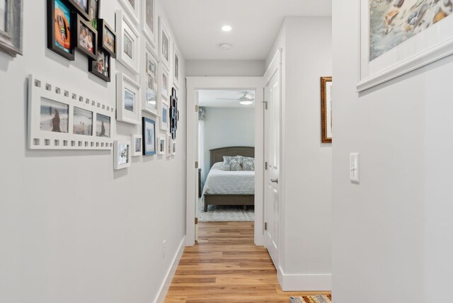 corridor with recessed lighting, light wood-style flooring, and baseboards