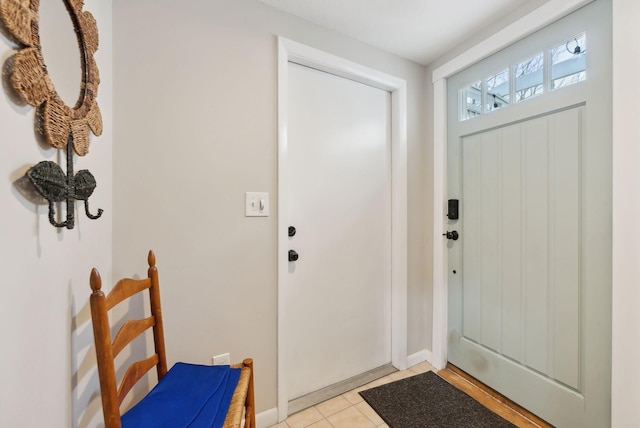 entryway featuring light tile patterned floors and baseboards