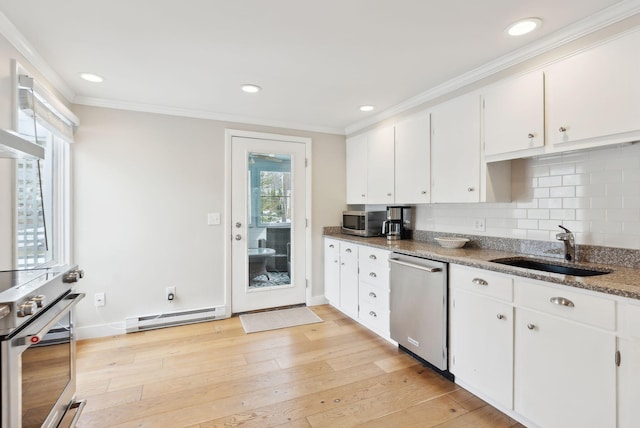 kitchen with a baseboard radiator, a sink, stainless steel appliances, light wood-style floors, and crown molding