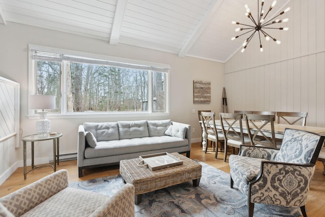 living area featuring lofted ceiling with beams, a notable chandelier, plenty of natural light, and baseboard heating