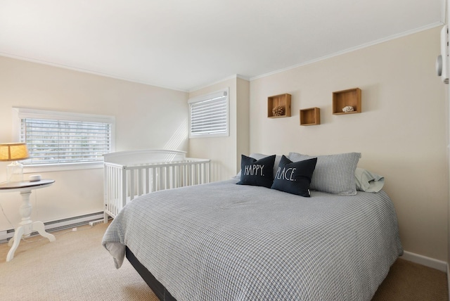 carpeted bedroom with baseboard heating, crown molding, and baseboards