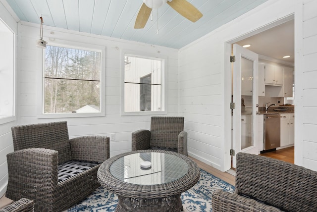 living area with wooden ceiling, a ceiling fan, and light wood finished floors