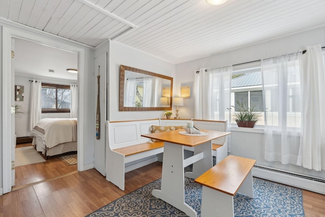 35 Grove Ave, Old Orchard Beach, ME 04064 - dining room featuring light wood finished floors, crown molding, wood ceiling, and a baseboard heating unit