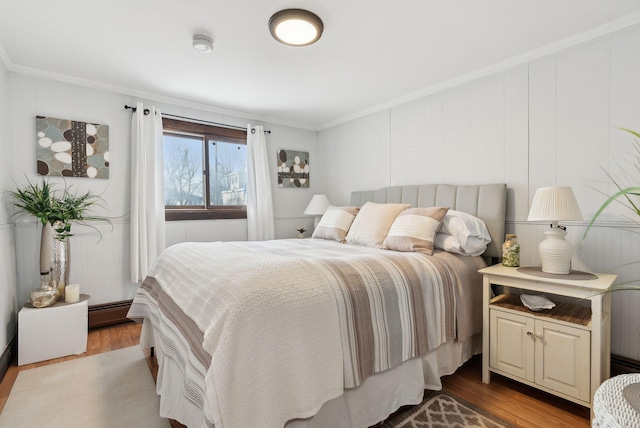35 Grove Ave, Old Orchard Beach, ME 04064 - bedroom featuring a baseboard heating unit, wood finished floors, and ornamental molding