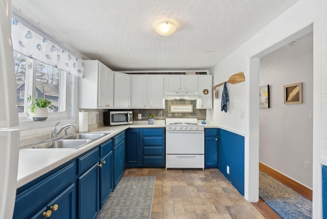 35 Grove Ave, Old Orchard Beach, ME 04064 - kitchen with blue cabinets, white range with gas cooktop, under cabinet range hood, stainless steel microwave, and a sink