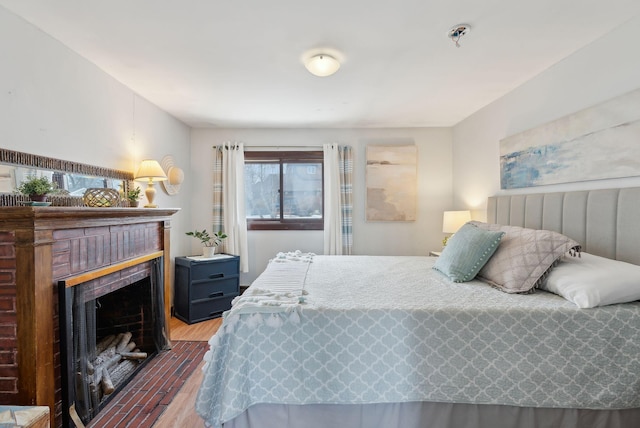 35 Grove Ave, Old Orchard Beach, ME 04064 - bedroom featuring a fireplace with flush hearth and wood finished floors
