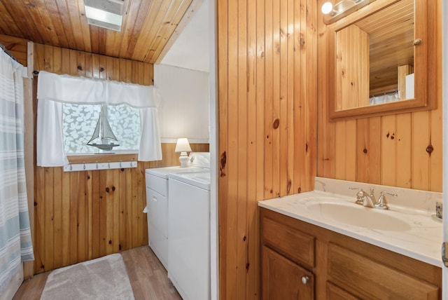 35 Grove Ave, Old Orchard Beach, ME 04064 - full bathroom featuring independent washer and dryer, wood finished floors, wooden walls, wooden ceiling, and vanity