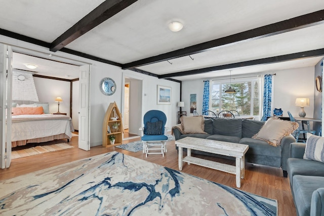 35 Grove Ave, Old Orchard Beach, ME 04064 - living area featuring beam ceiling, wood finished floors, and baseboards