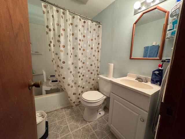 bathroom featuring tile patterned flooring, shower / tub combo with curtain, toilet, and vanity