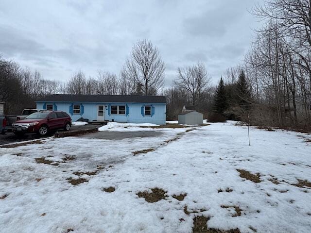 view of front of home with a storage unit and an outdoor structure