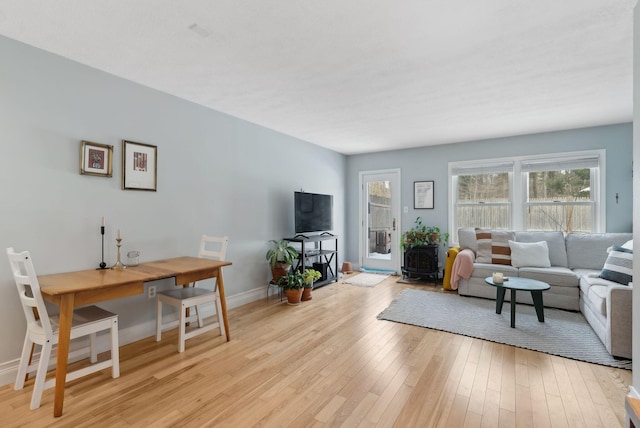 living room featuring light wood-type flooring and baseboards