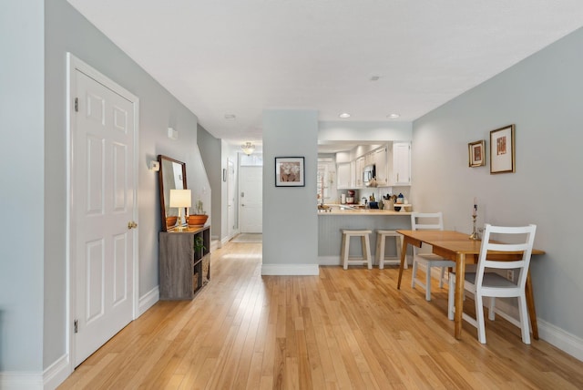 dining room featuring recessed lighting, light wood-style floors, and baseboards