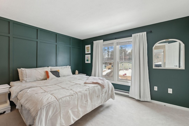 bedroom with a decorative wall, light colored carpet, and baseboards