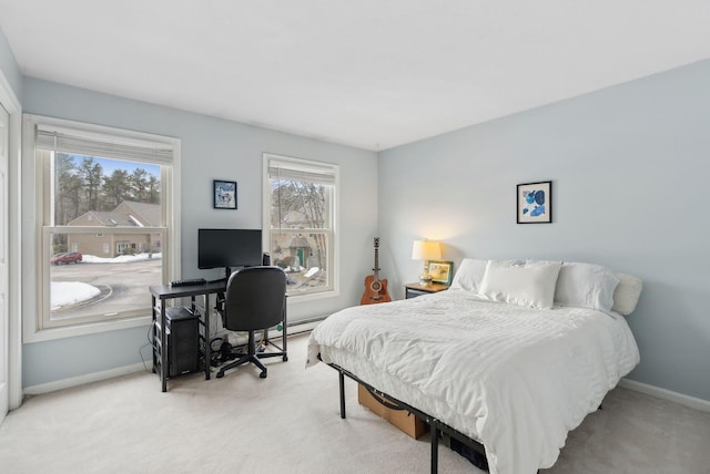 bedroom featuring baseboards and light colored carpet