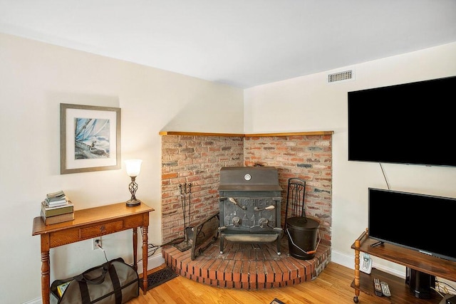 101 Whites Bridge Rd, Windham, ME 04062 - living room featuring a wood stove, baseboards, and wood finished floors