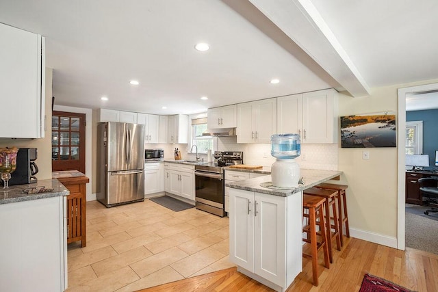101 Whites Bridge Rd, Windham, ME 04062 - kitchen featuring appliances with stainless steel finishes, a peninsula, white cabinets, a sink, and stone counters