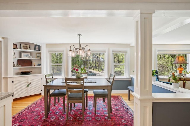 101 Whites Bridge Rd, Windham, ME 04062 - dining area with light wood-type flooring, a chandelier, and built in features