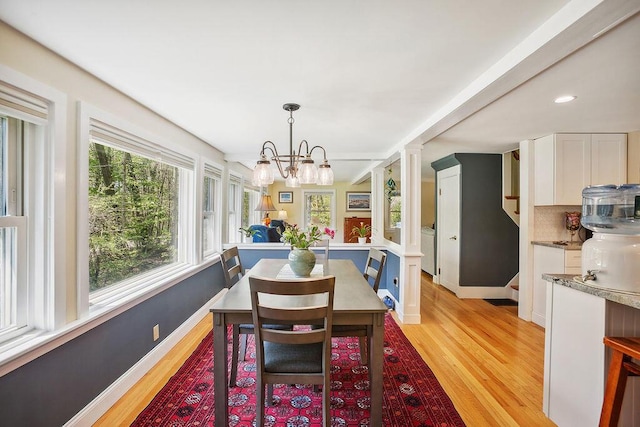 101 Whites Bridge Rd, Windham, ME 04062 - dining space featuring light wood-style floors, a chandelier, plenty of natural light, decorative columns, and recessed lighting