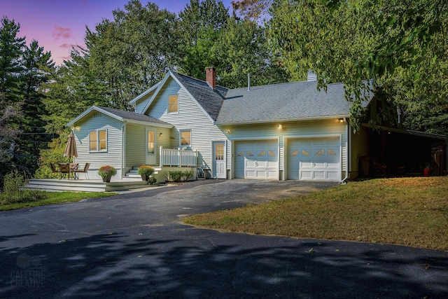 101 Whites Bridge Rd, Windham, ME 04062 - view of front of house with an attached garage, driveway, a shingled roof, a chimney, and a lawn