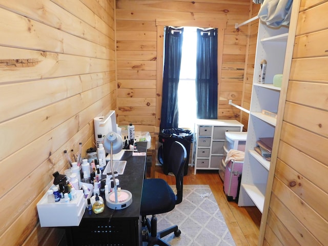 office space featuring wood-type flooring and wood walls