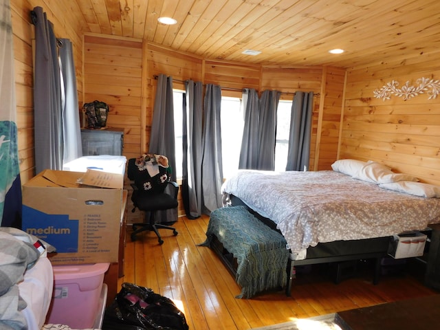 bedroom featuring wooden ceiling, light wood-style flooring, and wood walls