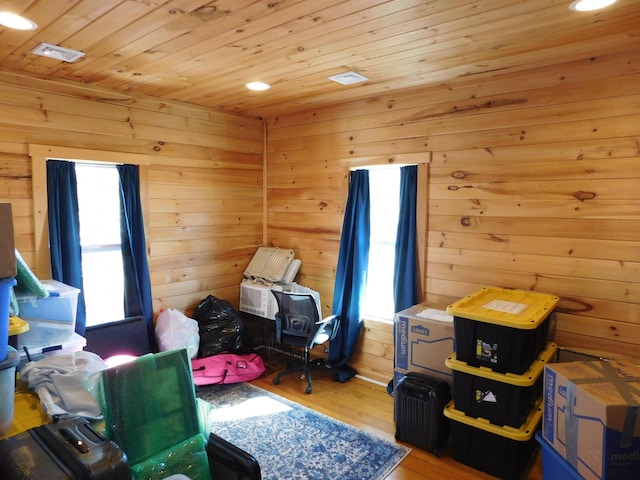 bedroom featuring wood ceiling, hardwood / wood-style floors, and wood walls