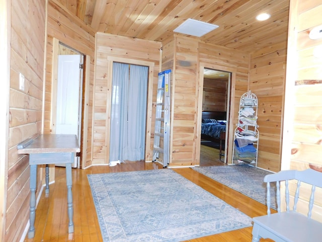 unfurnished bedroom featuring wood walls, wooden ceiling, and wood finished floors