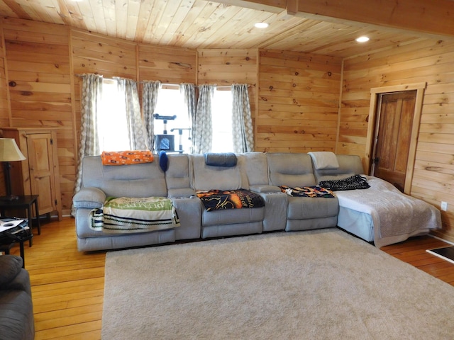 living area with hardwood / wood-style flooring, recessed lighting, wood ceiling, and wood walls