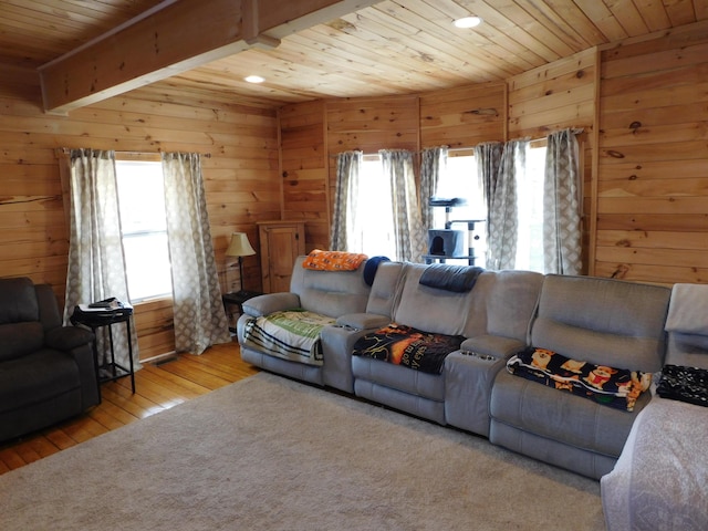 living room with beamed ceiling, wood finished floors, wooden walls, and wooden ceiling