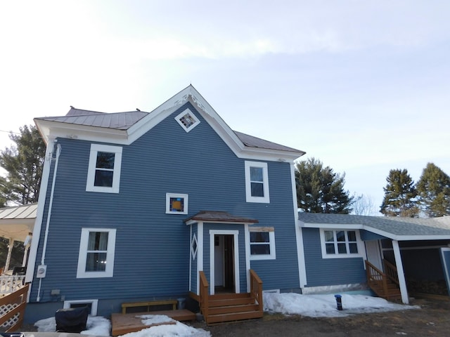 rear view of house with a standing seam roof and metal roof