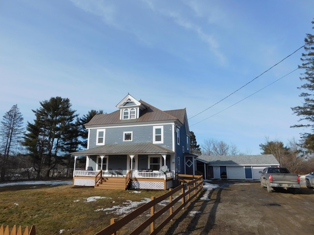 view of front of property featuring covered porch and metal roof