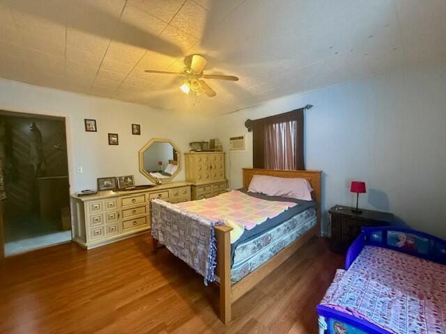 bedroom with wood finished floors and a ceiling fan
