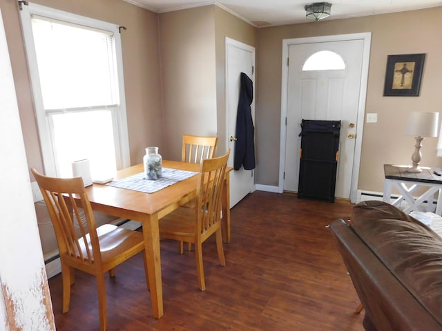 dining area featuring a baseboard heating unit, dark wood-style floors, and baseboards