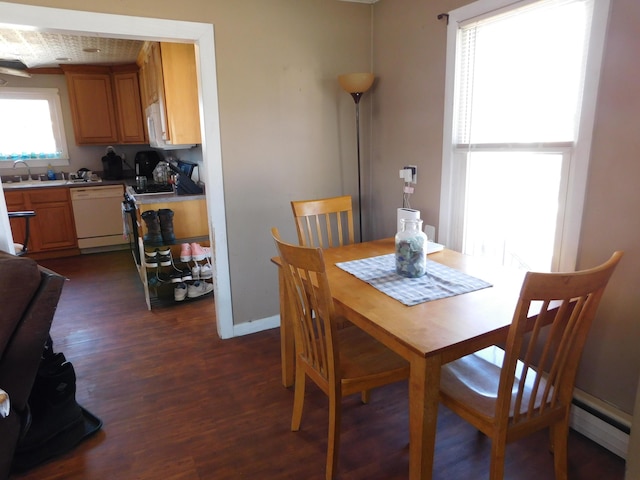 dining area with a baseboard radiator, baseboards, and dark wood-style floors