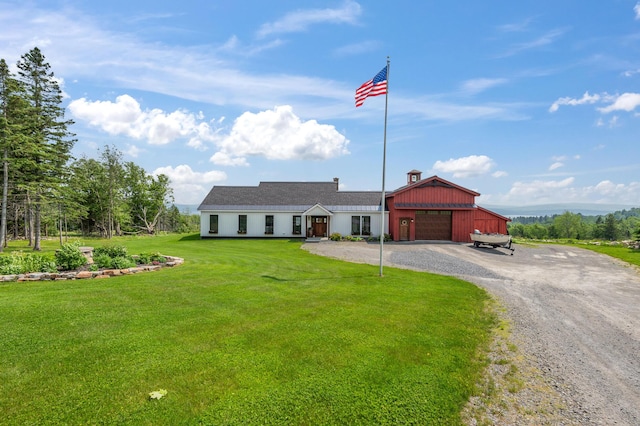 3062 Main St, Rangeley, ME 04970 - view of front of property with gravel driveway, a front yard, and a garage