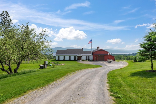 3062 Main St, Rangeley, ME 04970 - ranch-style house with driveway, a front lawn, an outbuilding, and an attached garage