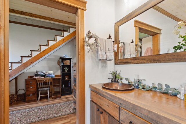 3062 Main St, Rangeley, ME 04970 - bathroom featuring beam ceiling, vanity, and wood finished floors