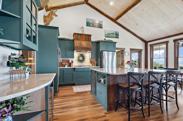 3062 Main St, Rangeley, ME 04970 - kitchen featuring stainless steel appliances, high vaulted ceiling, a kitchen breakfast bar, light wood-type flooring, and wood ceiling
