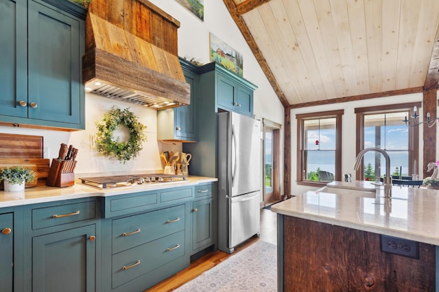 3062 Main St, Rangeley, ME 04970 - kitchen with stainless steel appliances, custom range hood, wooden ceiling, light wood finished floors, and lofted ceiling