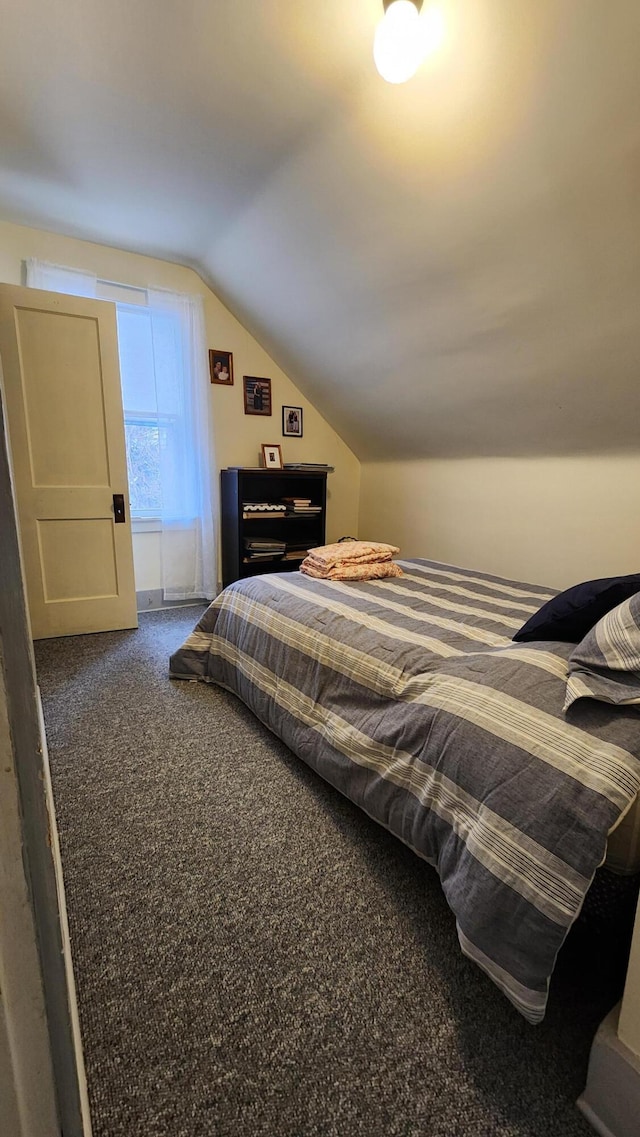 carpeted bedroom featuring vaulted ceiling