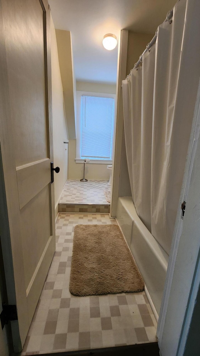 bathroom with tile patterned floors and shower / tub combo with curtain